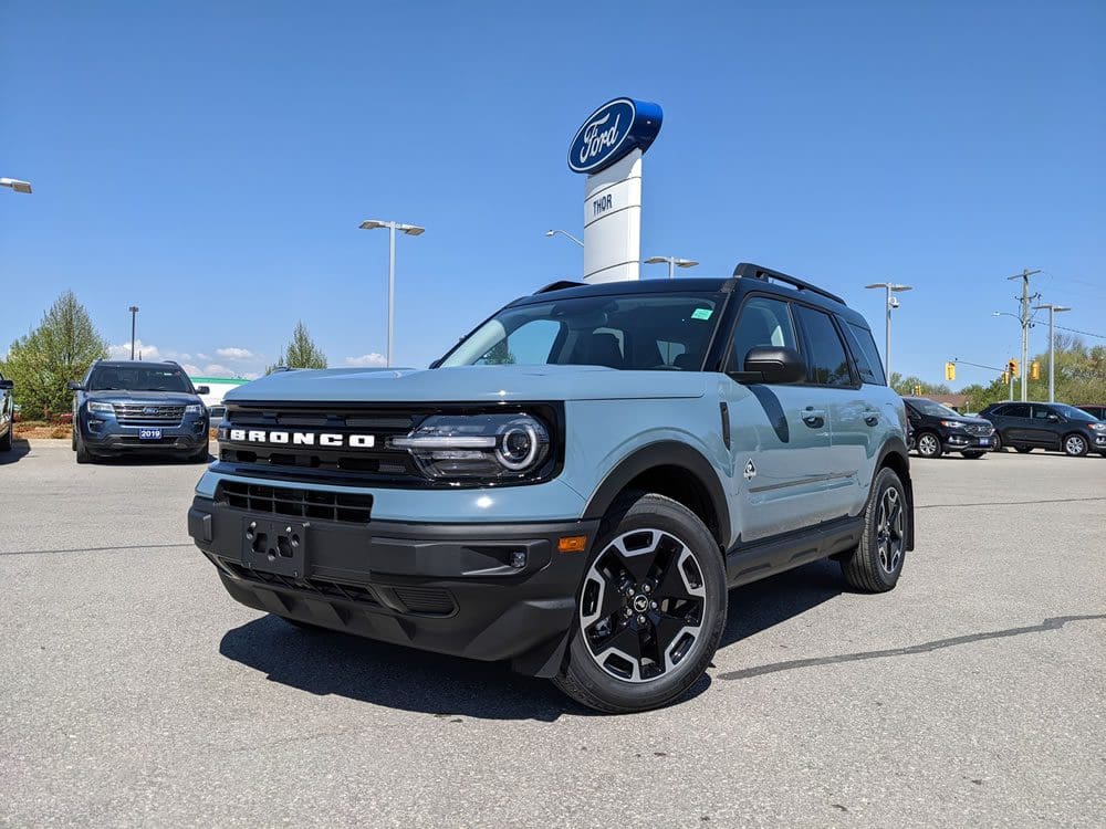 Ford Bronco Sport in front of Ford Dealership Sign